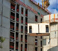 Crane lifting a wooden building module to its position in the structure  Construction site of an office building in Berlin  The new structure will be built in modular timber construction  